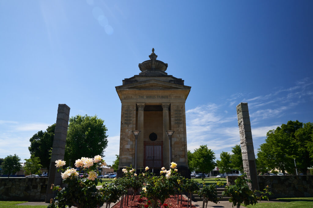 Colac memorial surrounded by rose bushes.